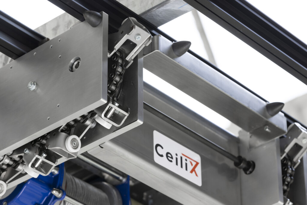 Close-up of the CeiliX overhead shuttle’s chain-driven guide bracket for precise and reliable intralogistics automation—an advanced solution for efficient warehouse operations.